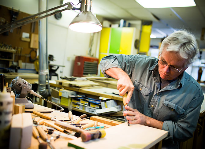 Woodworker Gene Kelly using tools in Workshop