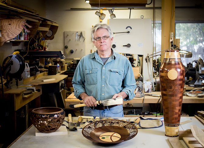 Woodworker Gene Kelly displaying woodturning